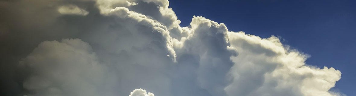 Fluffy white clouds on a blue sky background