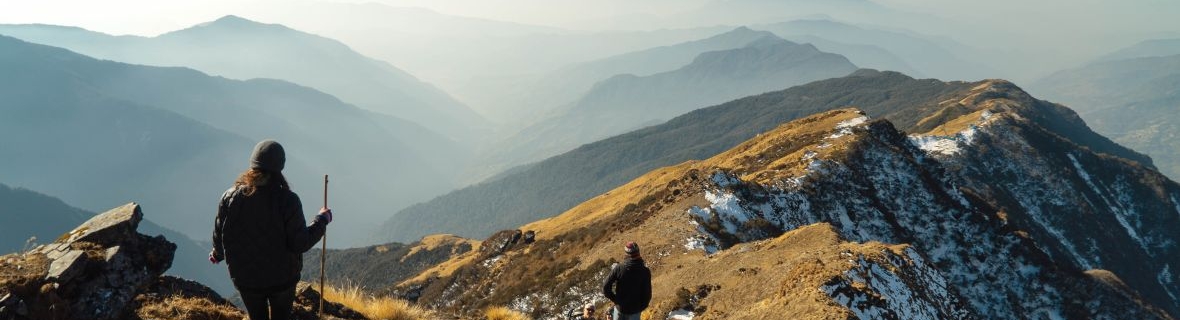 Mountain top landscape with hikers in the foreground